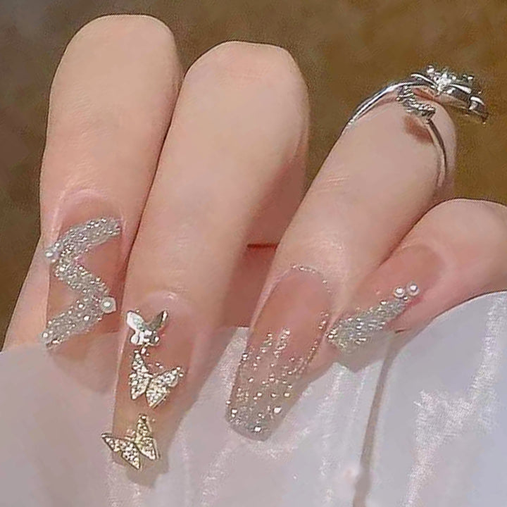 Artificial nails with sparkling rhinestone and bow accents Bowlift
