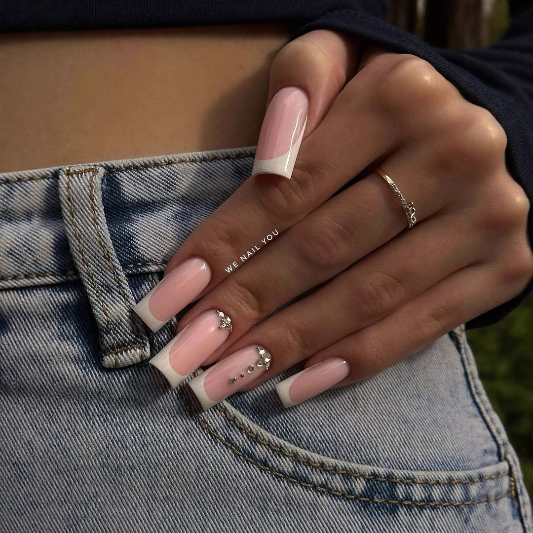Acrylic nail set with elegant French tips and sparkling rhinestone accents Bowlift