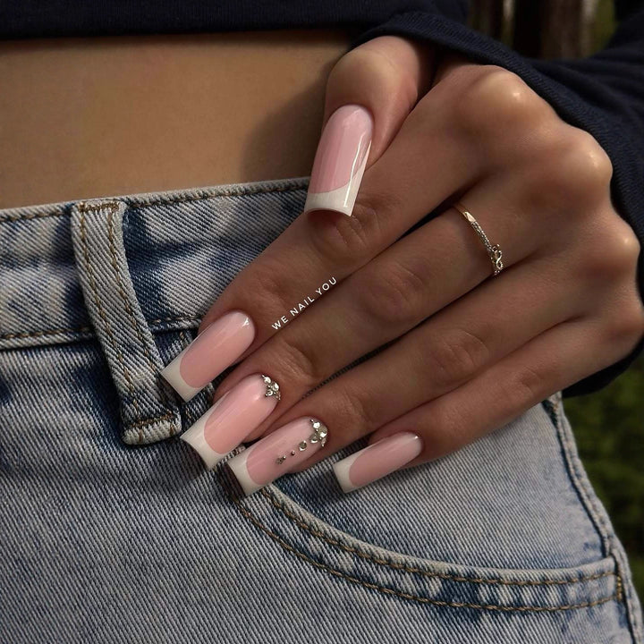 Acrylic nail set with elegant French tips and sparkling rhinestone accents Bowlift