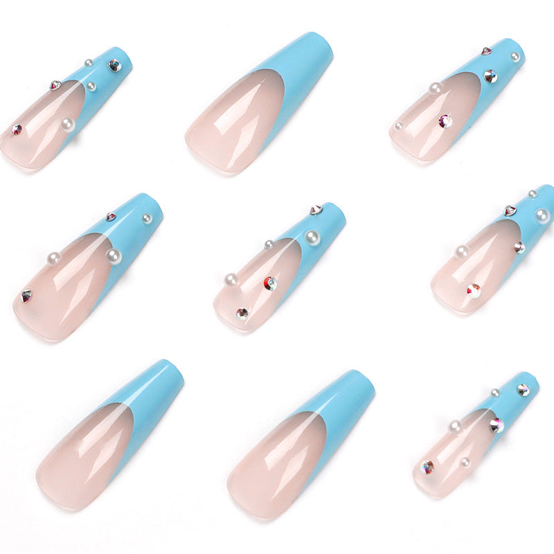 Artificial nail extensions with glitter and pearl accents Bowlift
