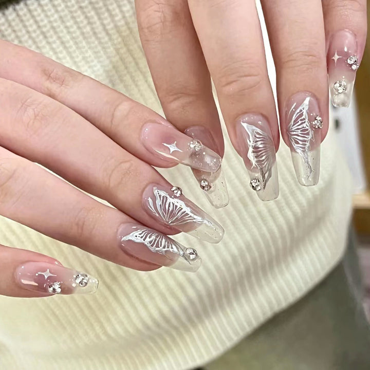 Elegant artificial nails with floral designs and glitter accents Bowlift
