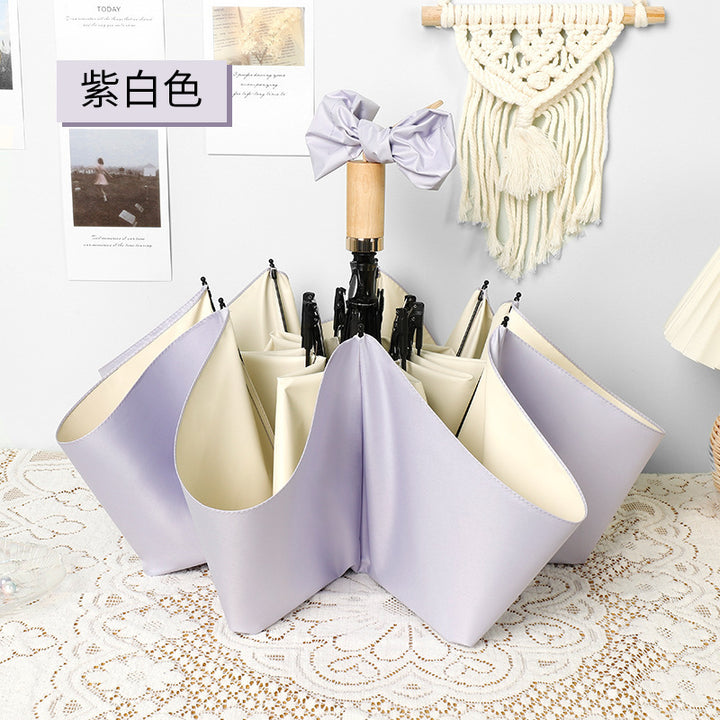 Ladies elegant folding umbrella in portrait format with stylish wooden handle Bowlift
