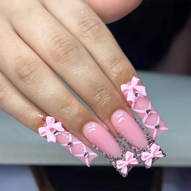 Artificial nail set with romantic bow and glitter accents Bowlift