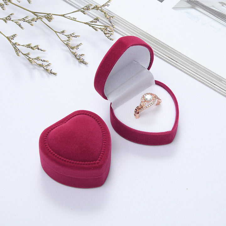 Heart-shaped velvet ring box with cushioned white interior and secure ring slot Bowlift