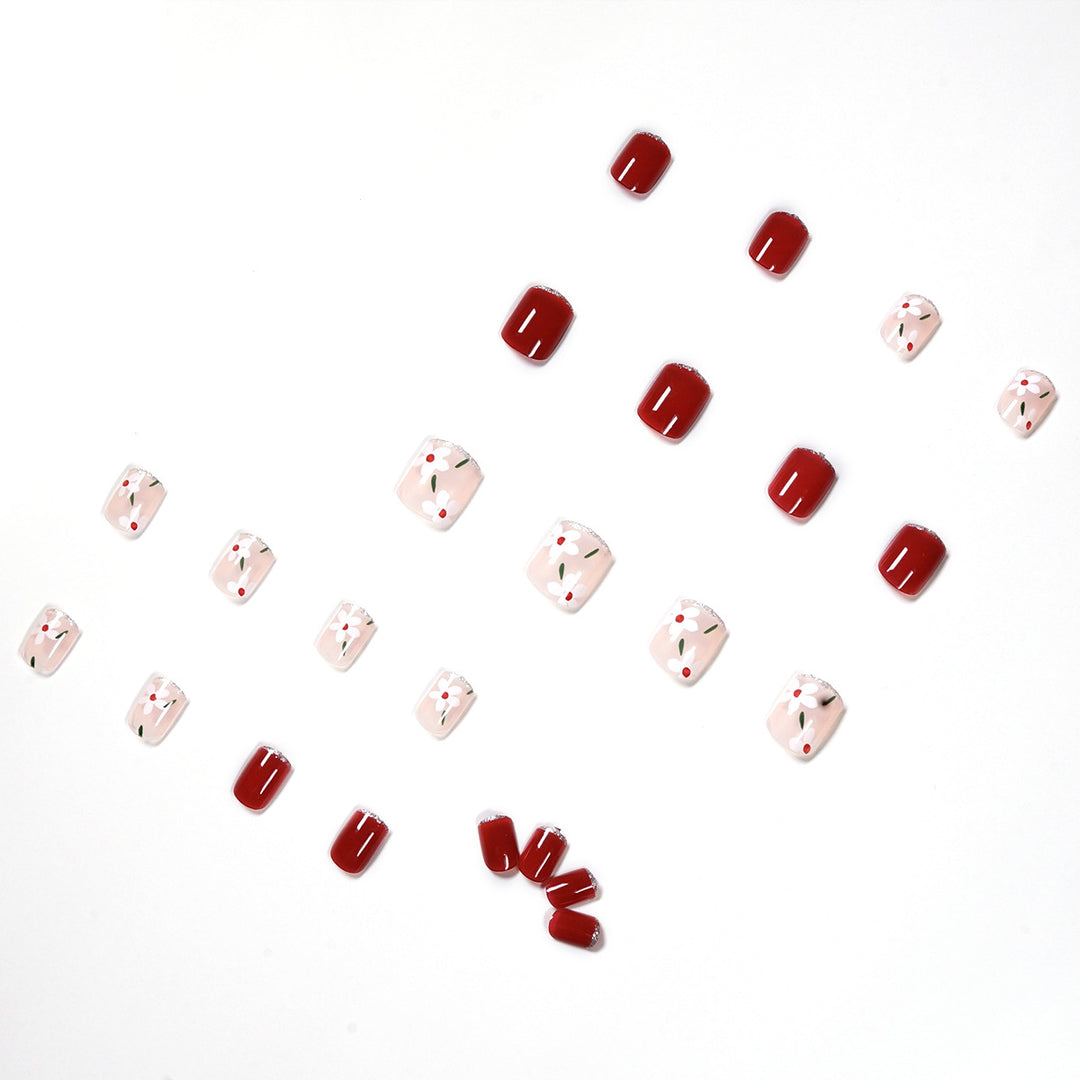 Artful nail art with floral motifs and glitter accents Bowlift