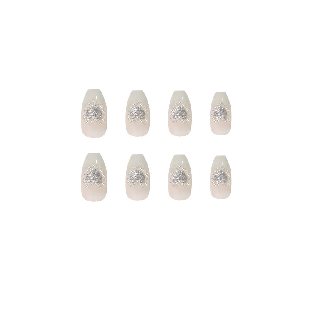 Artificial nail art with heart and rhinestone decorations Bowlift