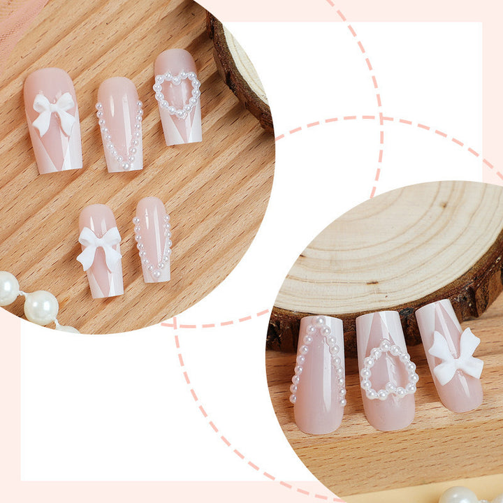Artificial nail set with filigree hearts and bow decorations Bowlift