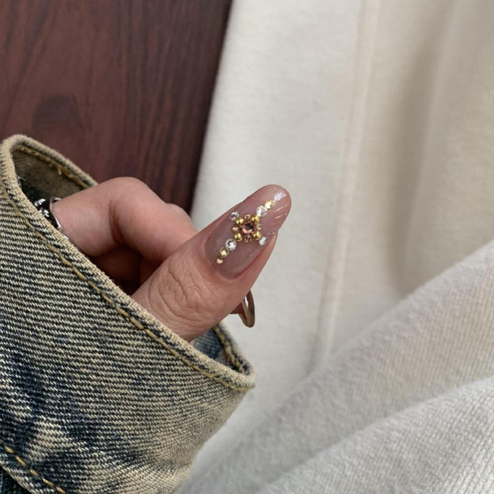 Artificial nail set with elegant patterns and glitter accents Bowlift