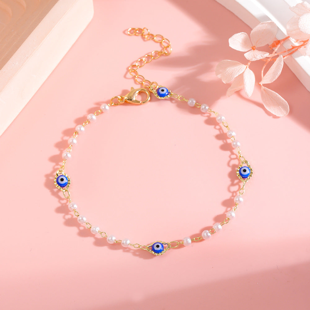 Elegant Pearl and Eye Charm Necklace Bowlift