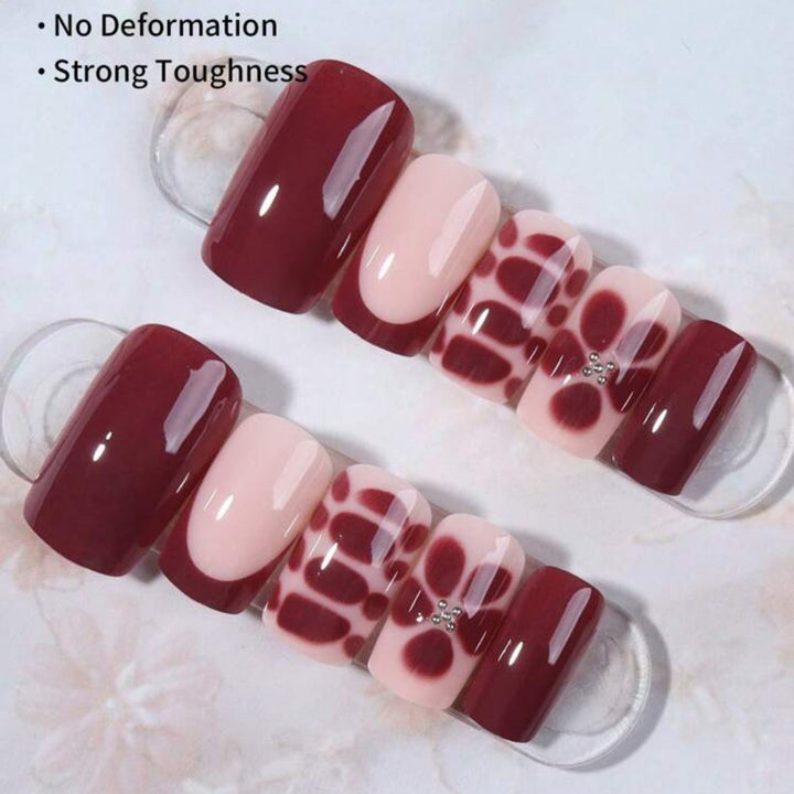 Artificial nail set with elegant geometric designs and accentuating rhinestone details Bowlift