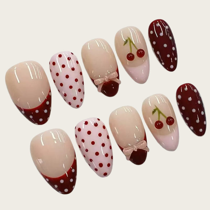 Artfully designed nail tips with cherry and dot motifs Bowlift