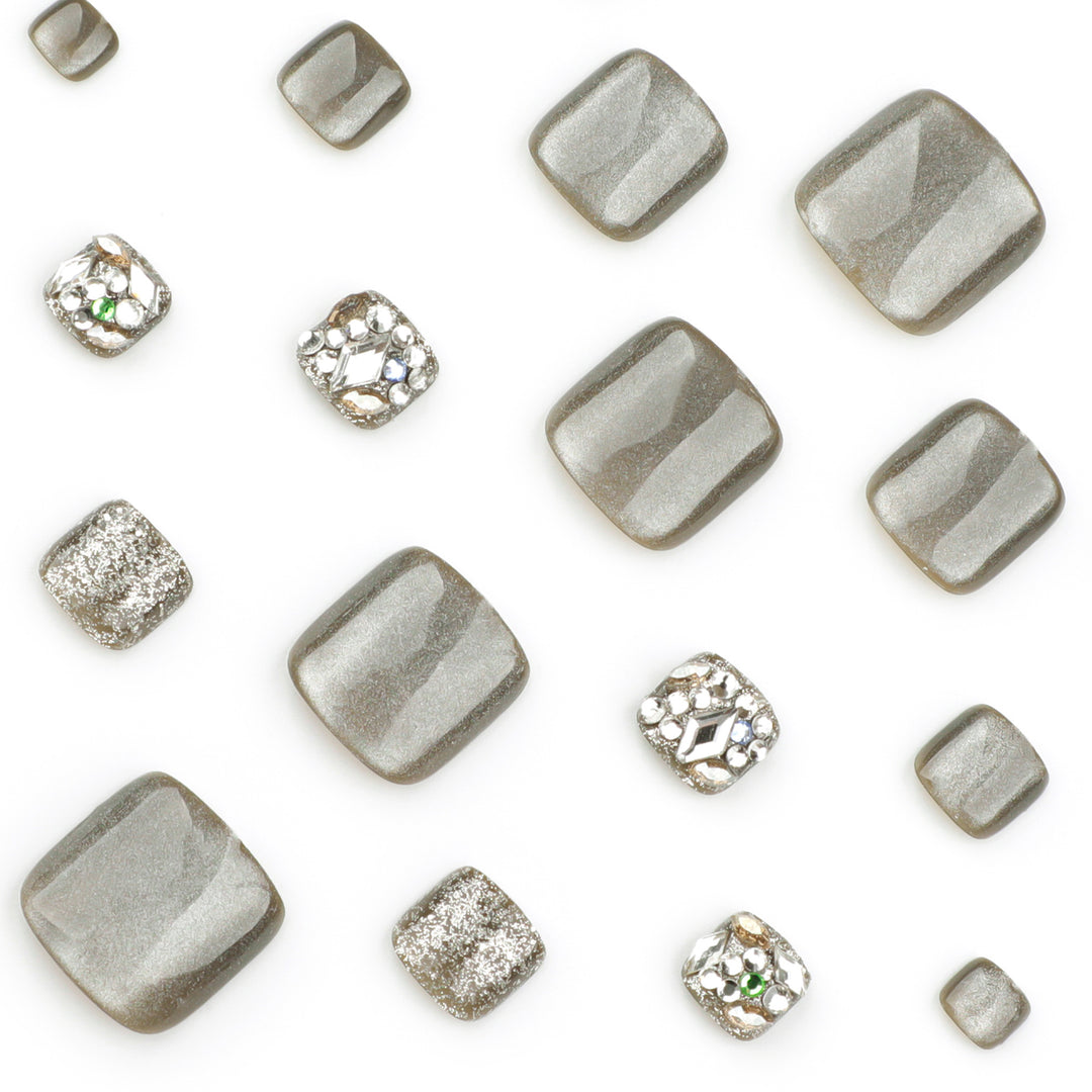 Artful toenail design with glitter and rhinestone decorations Bowlift