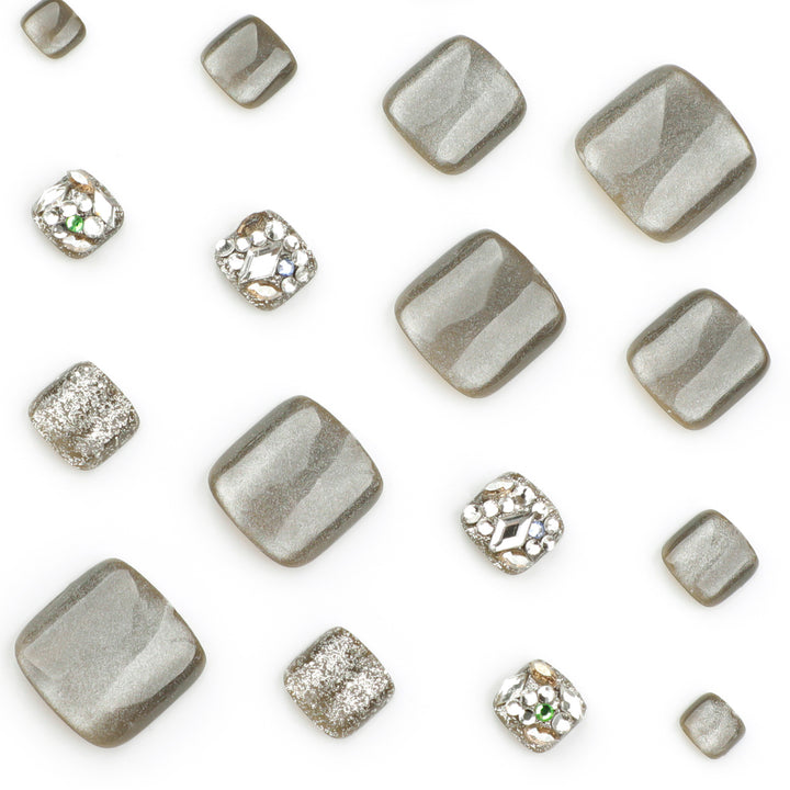 Artful toenail design with glitter and rhinestone decorations Bowlift