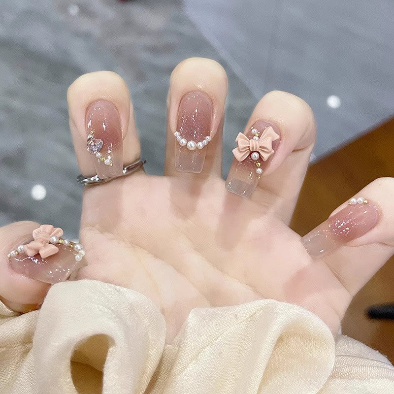 Glamorous artificial nails with delicate flower and glitter effects Bowlift