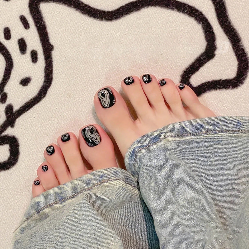 Artistic toenail art with rhinestone and glitter elements Bowlift
