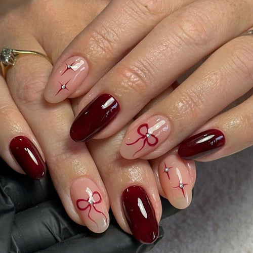 Artful nail art with elegant bows and rhinestone embellishments Bowlift