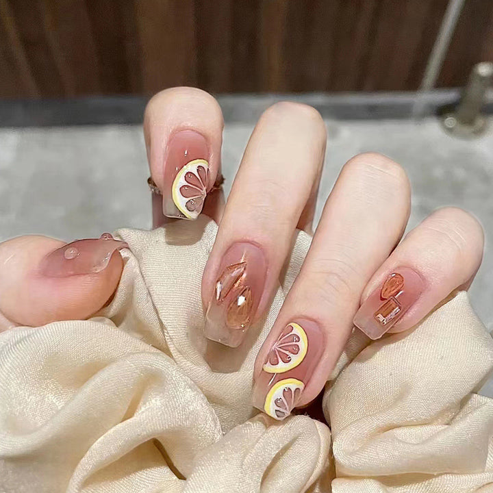 Artificial nail set with cheerful citrus motifs and elegant designs Bowlift
