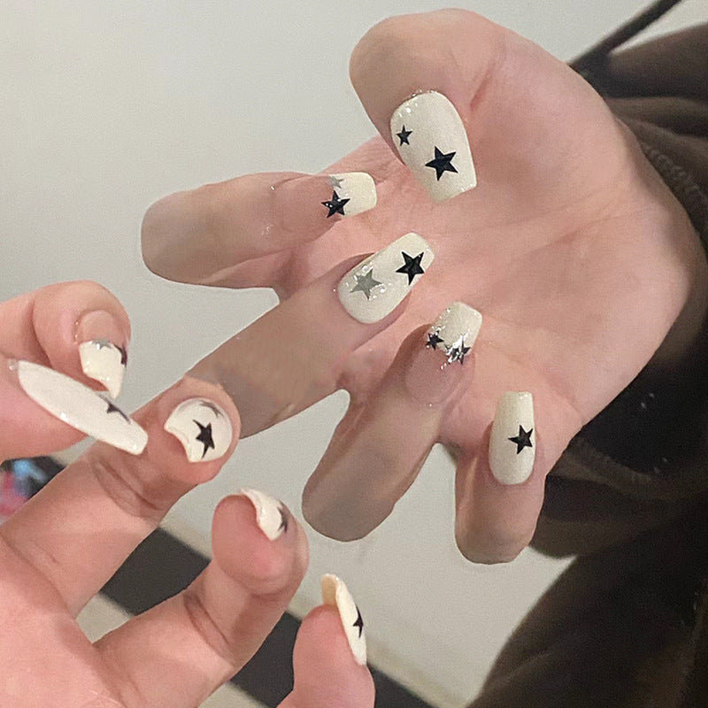 Artificial nail set with glamorous star design and sparkling accents Bowlift