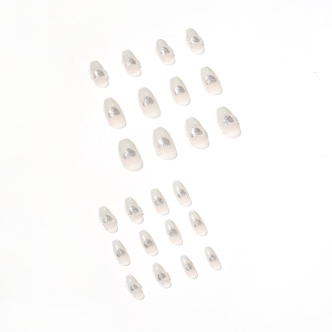 Artificial nail art with heart and rhinestone decorations Bowlift
