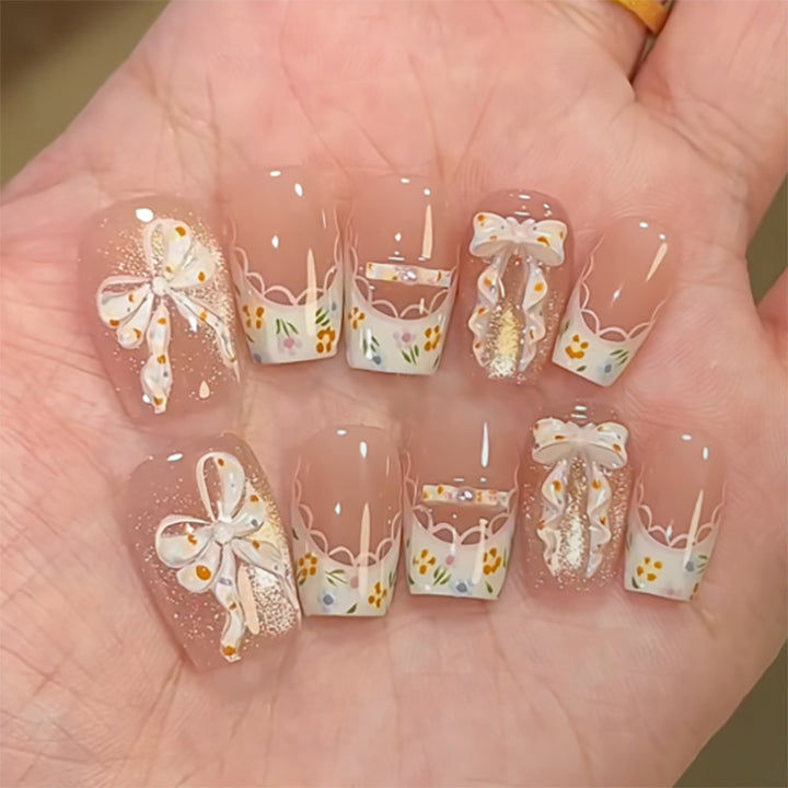 Artful Nail Extensions with Floral Design and Bow Accents Bowlift