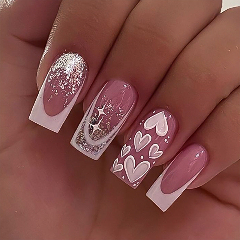 Artful Nail Extensions with Modern Glitter Design and Heart Accents Bowlift