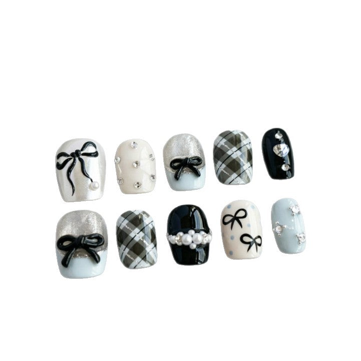 Artificial nails with elegant bows and rhinestones Bowlift