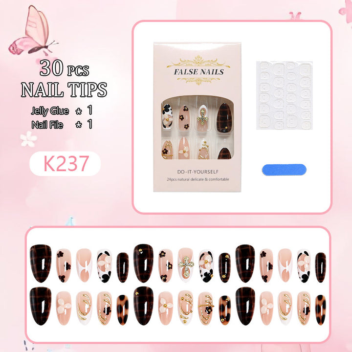 Artificial nails set with elegant gold accents and floral embellishments Bowlift