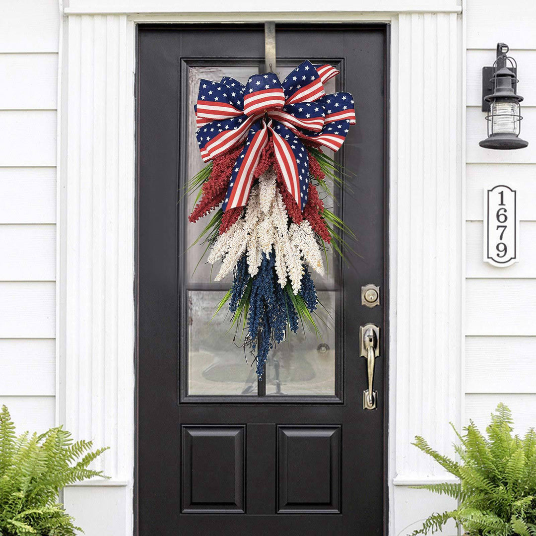Independence Day tapering teardrop door swag with wired stars-and-stripes bow and textured faux floral sprays Bowlift