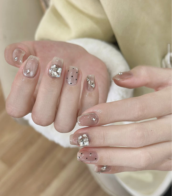Artistic Press-On Nail Design with Floral and Glitter Accents Bowlift