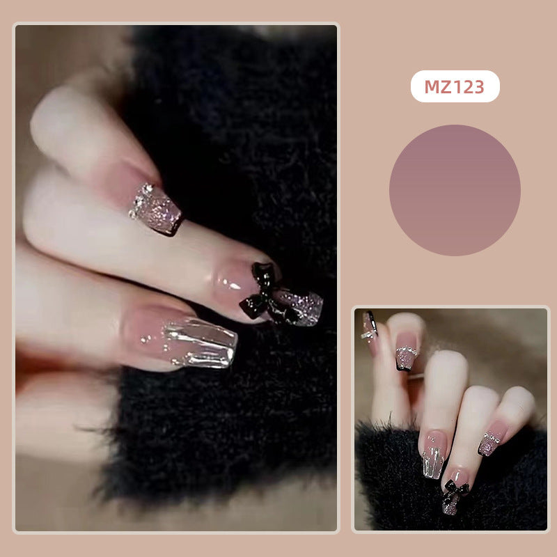 Elegant nail design with bow and rhinestone details Bowlift