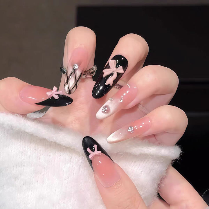 Artificial nails with playful bow design and glitter effects Bowlift