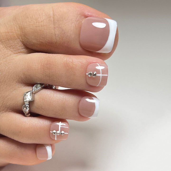 Artful toenail design with elegant style and rhinestone embellishments Bowlift