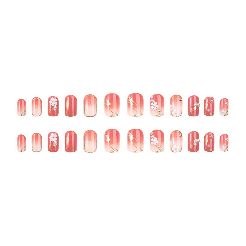 Acrylic nail set with elegant floral decorations and glamorous pearl accents Bowlift