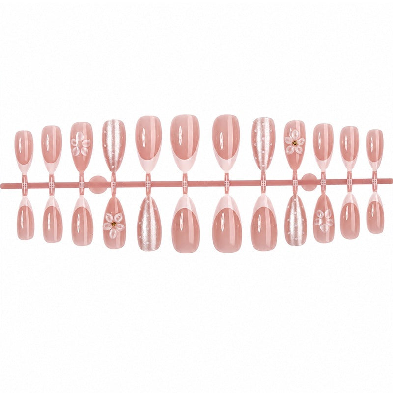 Artificial nail set with elegant French tips and delicate floral accents Bowlift