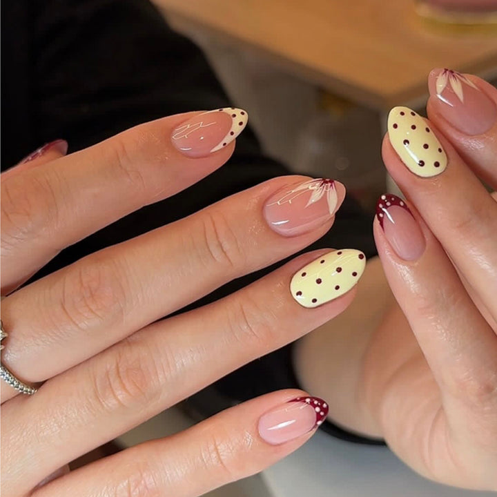 Artistic nail design with unique dots and floral embellishments Bowlift
