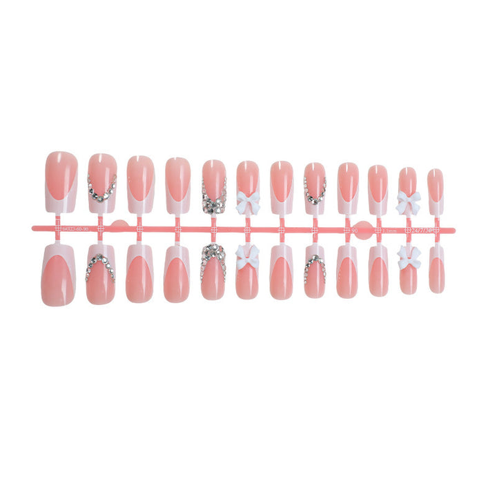 Acrylic nail set with glitter accents and decorative bows Bowlift