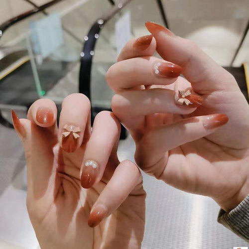 Artificial nails with glamorous bow and pearl decor Bowlift