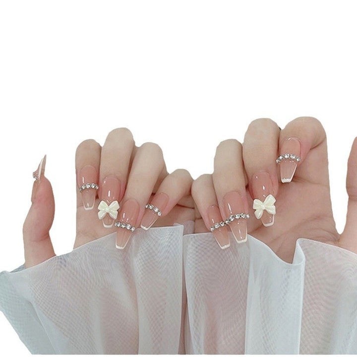 Artificial nails with elegant bow accents and pearl decorations Bowlift