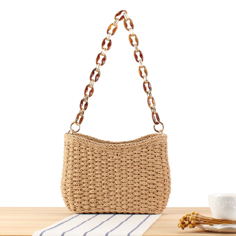 Stylish handbag made of woven natural material with exclusive chain accents Bowlift