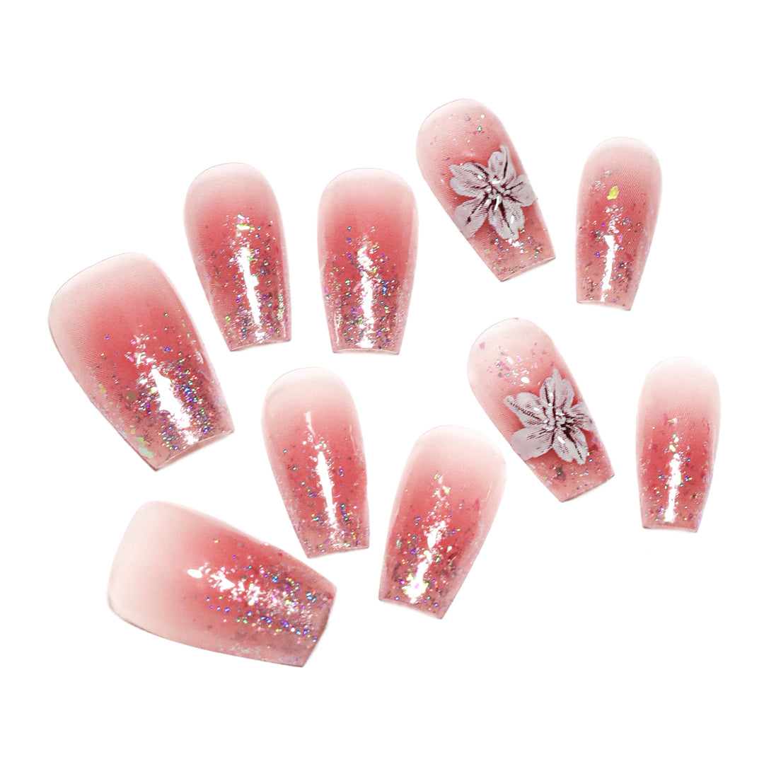 Artificial nail extensions with floral design and glitter accents Bowlift