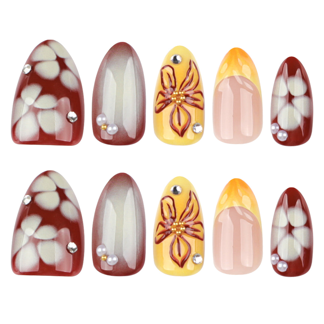 Artificial nail extensions with floral design and rhinestone embellishments Bowlift