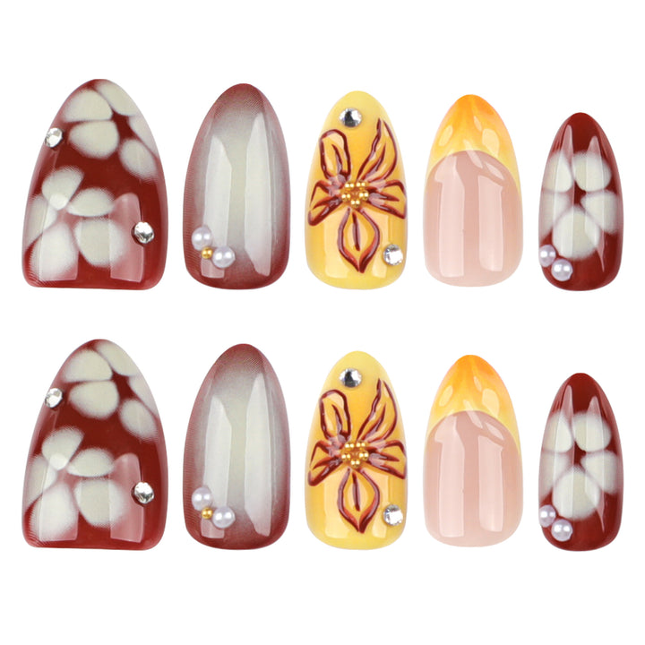 Artificial nail extensions with floral design and rhinestone embellishments Bowlift