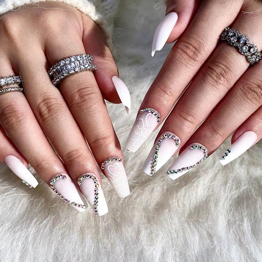 Artful Nail Extensions with Heart Design and Glitter Accents Bowlift