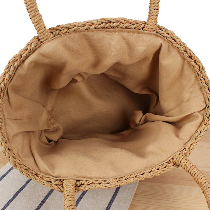 Basket bag made of woven natural material with leather handles Bowlift