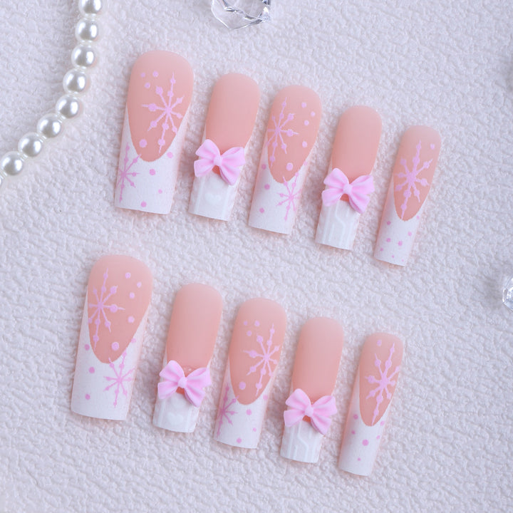 Artificial nail tips with playful bows and snowflake design Bowlift