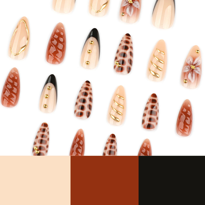 Artificial nails in modern stiletto design with golden accents Bowlift