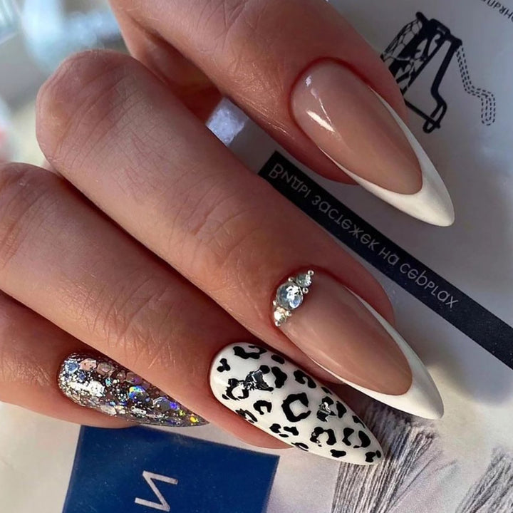 Artful stiletto nails with leopard patterns and glitter accents Bowlift
