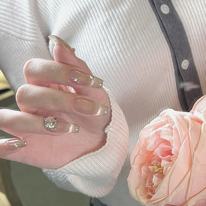 Acrylic nail set with glamorous glitter accents and elegant jewelry embellishments Bowlift