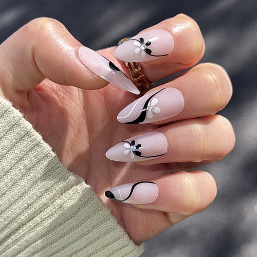 Artistic nail extensions with floral accents and glitter accents Bowlift