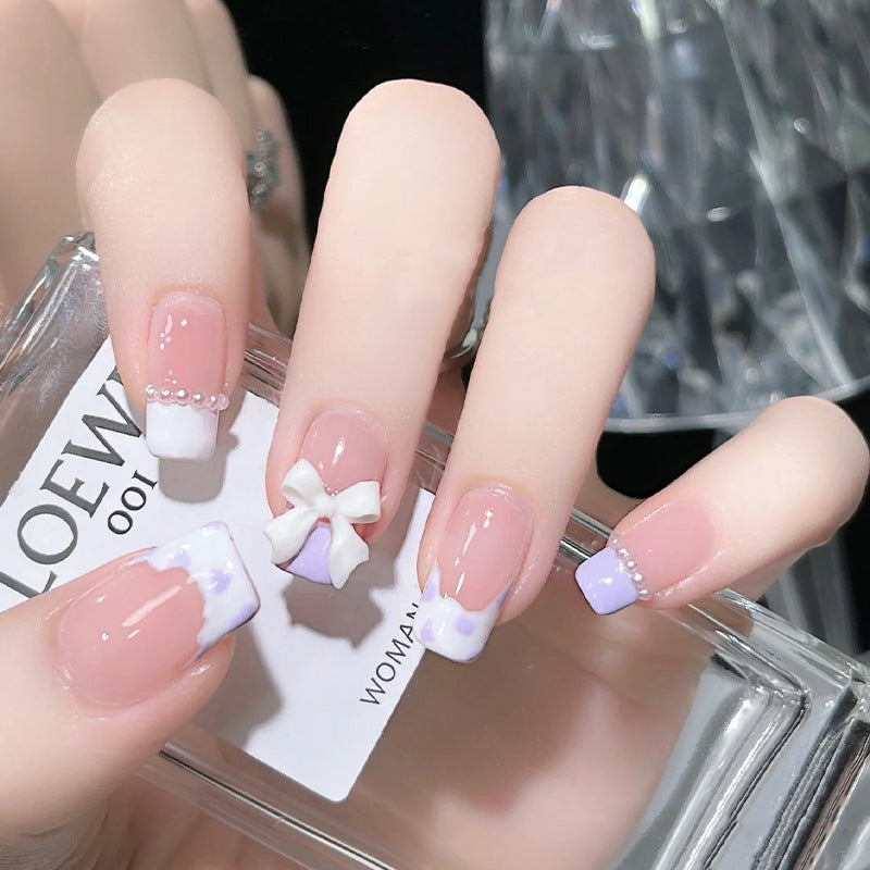 Nail art set with elegant wave patterns and delicate pearl accents Bowlift